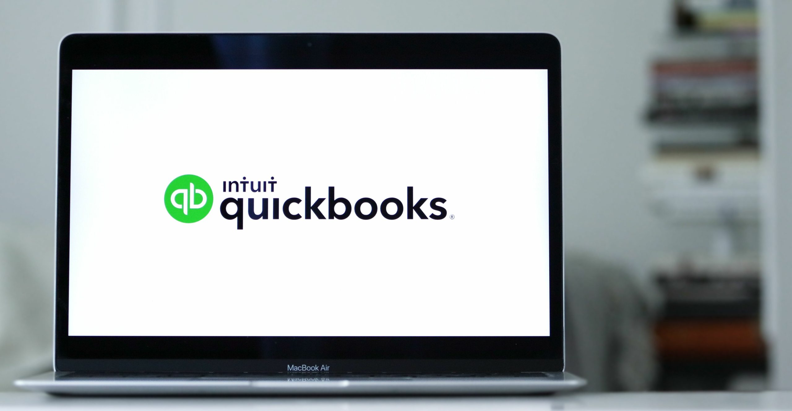 Laptop displays the logo of Quickbooks an accounting software program